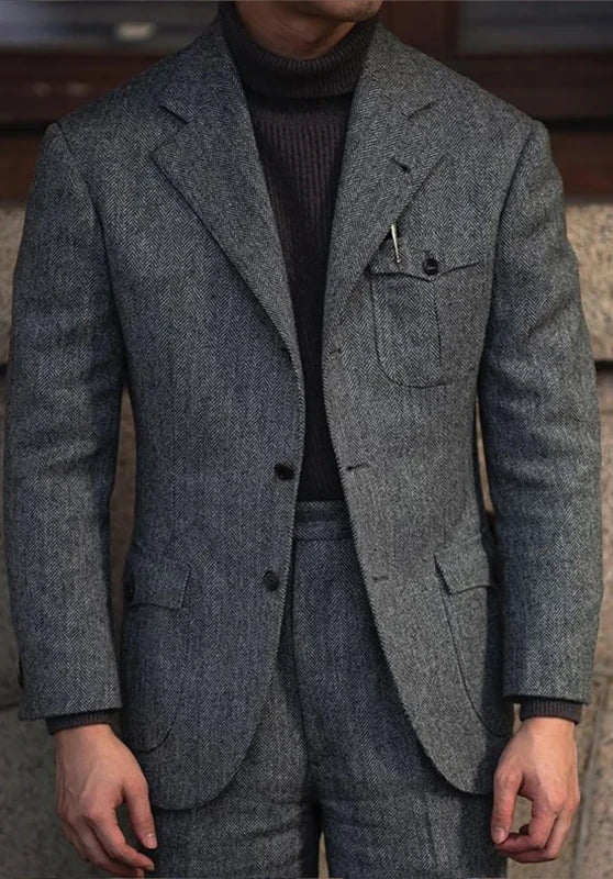 Men's herringbone tweed blazer, black wool-blend fabric slim-fit side profile with tailored fit