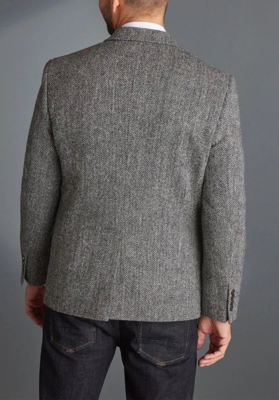 Men's herringbone tweed blazer, black wool-blend fabric slim-fit close-up fabric and pocket detail
