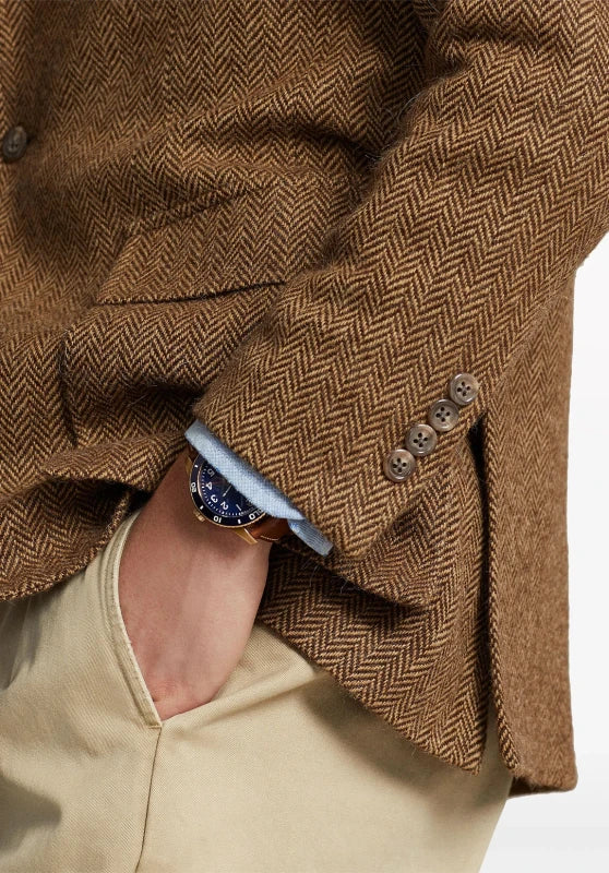 Men's herringbone tweed blazer, black wool-blend fabric classic-fit close-up fabric and pocket detail
